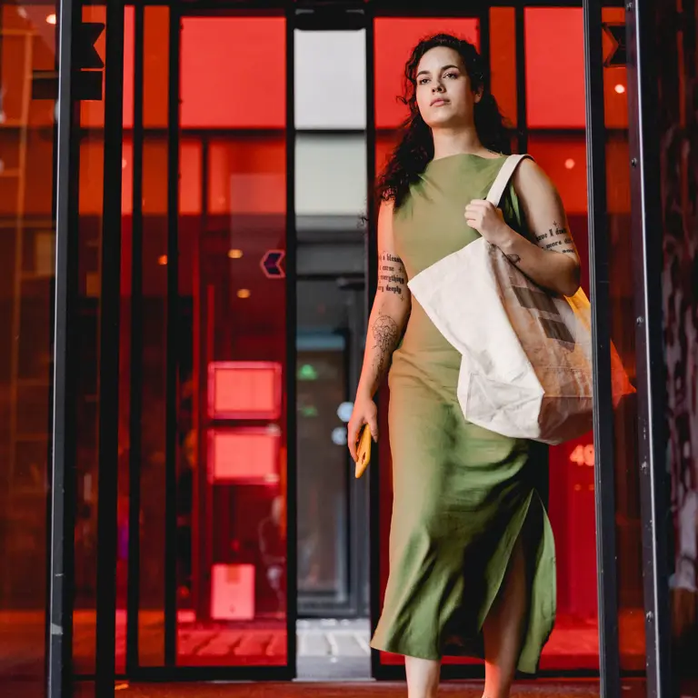 woman with a bag enters citizenM hotel